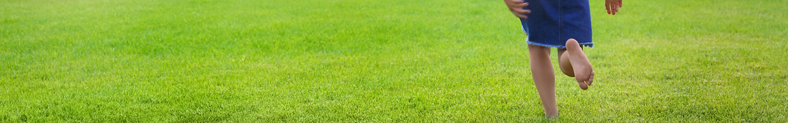 Child Running Barefoot in the Grass